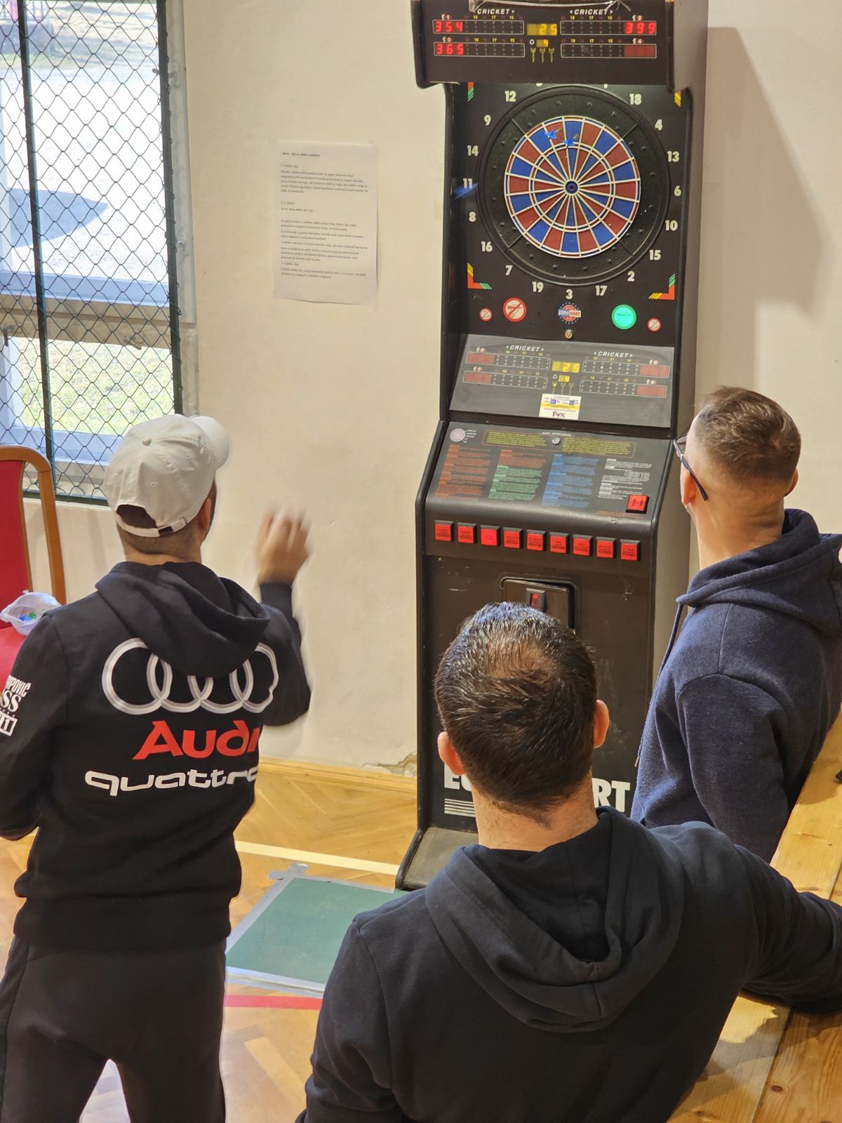 a group of people playing darts